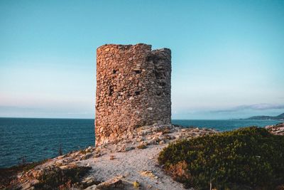 Castle by sea against clear sky