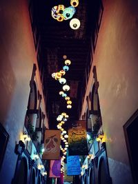 Low angle view of illuminated christmas lights hanging at night