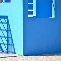 Shadow on blue wall of building