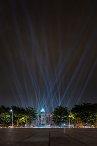Illuminated city against sky at night
