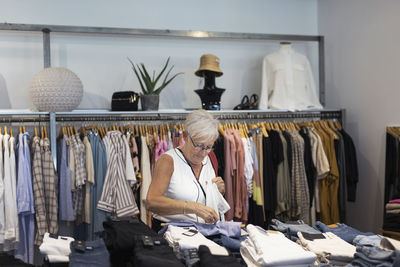 Senior woman doing shopping in clothes shop