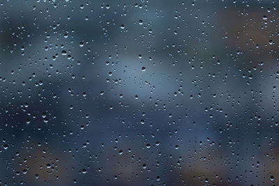 Full frame shot of wet glass window during rainy season