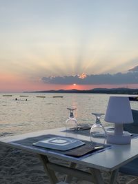 Table on the sand with romantic sunset view 