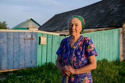 Full length of woman standing against built structure