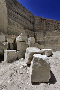 Stone wall of rock against sky