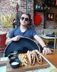 Young man sitting at restaurant