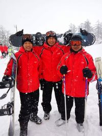 Portrait of people standing in snow during winter