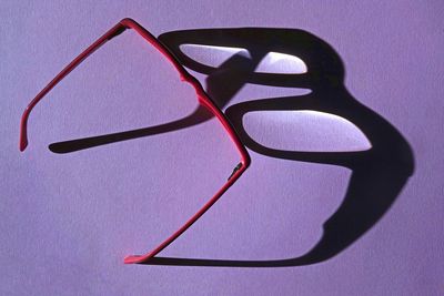 High angle view of eyeglasses on table against white background