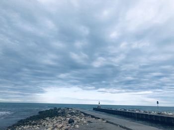 Road by sea against sky