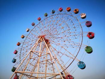 Low angle view of ferris wheel against sky