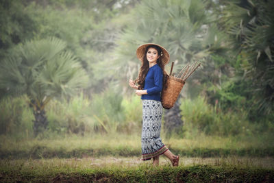 Full length of woman walking on field