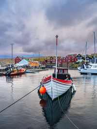 Boats moored at harbor