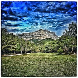 Scenic view of mountains against cloudy sky