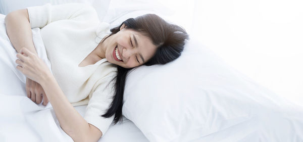 High angle view of woman lying on bed