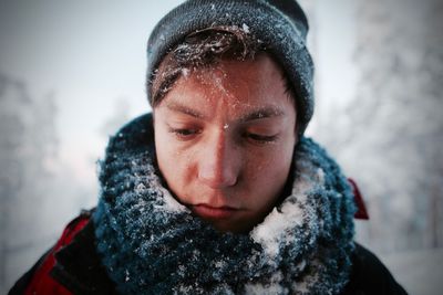 Close-up portrait of a man with snow