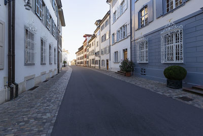 Empty alley amidst buildings in city