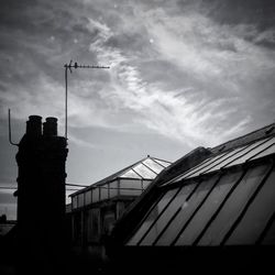 Low angle view of building against cloudy sky