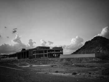 Abandoned building on field against sky