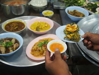 Close-up of hand holding food on table