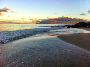 Scenic view of beach against sky during sunset