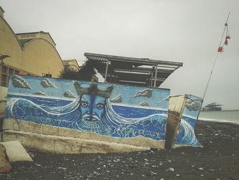 Graffiti on wall against clear sky