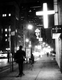 View of illuminated city street at night