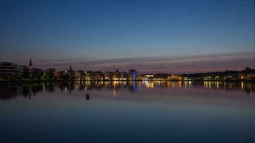 Reflection of illuminated buildings in water