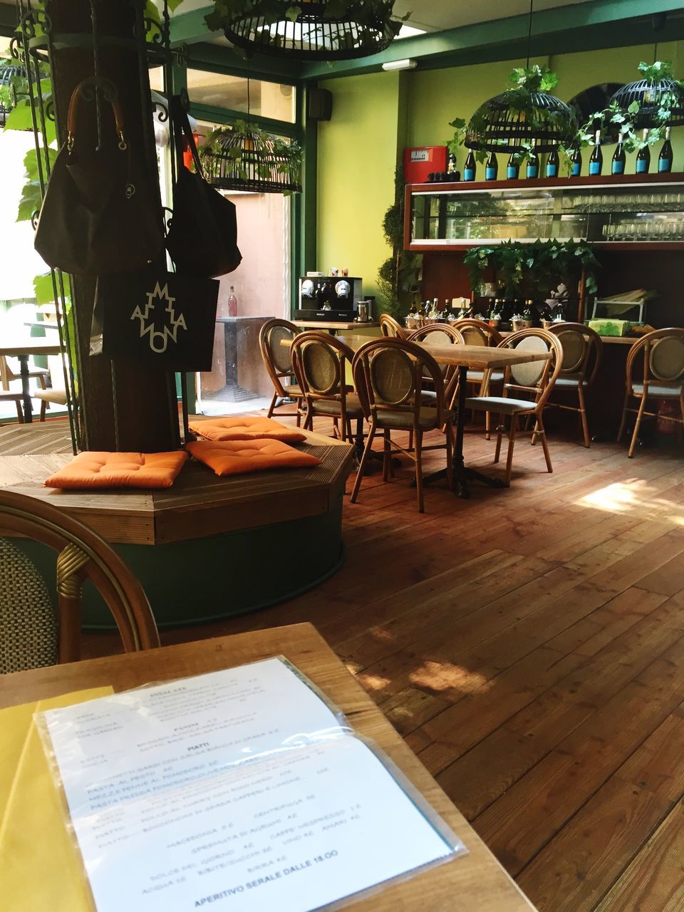 indoors, table, chair, restaurant, empty, absence, book, sitting, dining table, home interior, sidewalk cafe, cafe, furniture, education, window, relaxation, place setting, day, sunlight