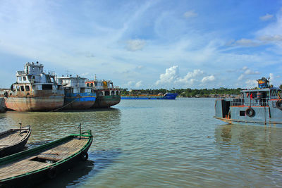 Boats moored in sea against sky