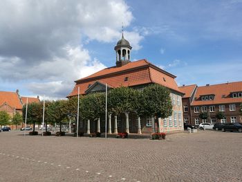 Street amidst buildings in city against sky