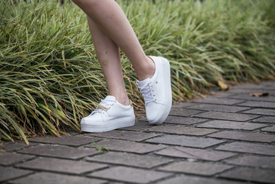 Low section of woman on footpath