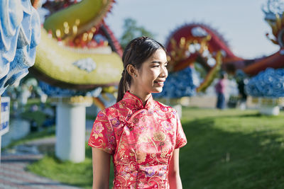 Happy chinese new year. asian woman wearing traditional cheongsam qipao dress.