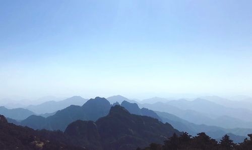 Scenic view of mountains against clear blue sky