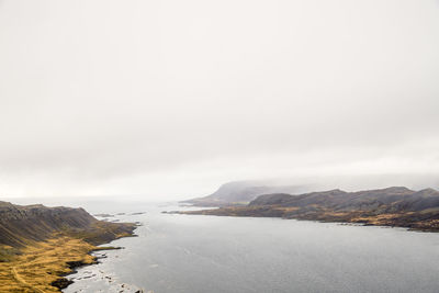 Scenic view of lake against sky during winter