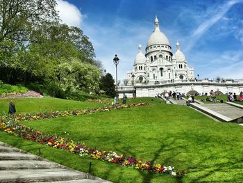 People visiting sacre-coeur against sky