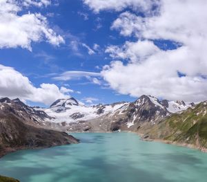 Scenic view of lake and mountains against sky