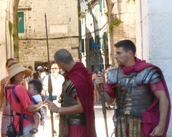 People standing by buildings in city