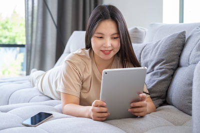 Young woman using tablet pc at home