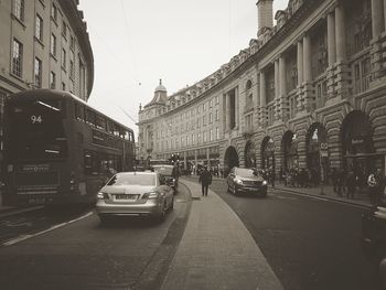 Vehicles on road along buildings