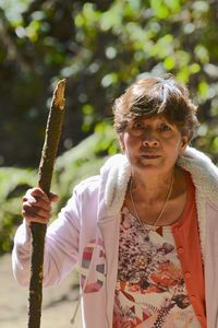 Portrait of woman holding stick