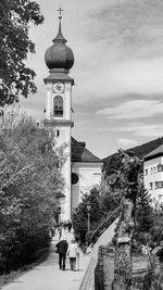 Tower amidst buildings in city against sky