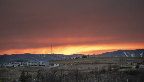 Scenic view of mountains against orange sky