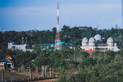 Panoramic view of trees and buildings against sky