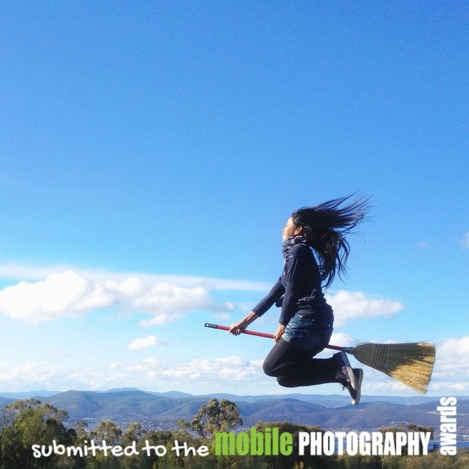 sky, full length, leisure activity, lifestyles, mountain, blue, casual clothing, cloud - sky, low angle view, cloud, men, standing, rear view, nature, day, landscape, freedom, mid-air