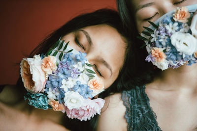 High angle view of woman and rose bouquet