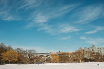 Snow covered city against sky