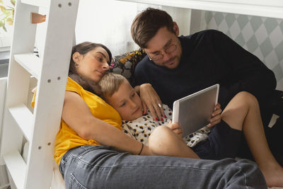 Parents with son on bed