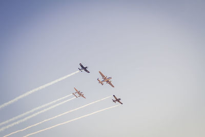 Low angle view of airplane flying against clear sky