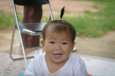 Portrait of messy baby smiling outdoors