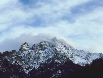 Scenic view of mountains against cloudy sky